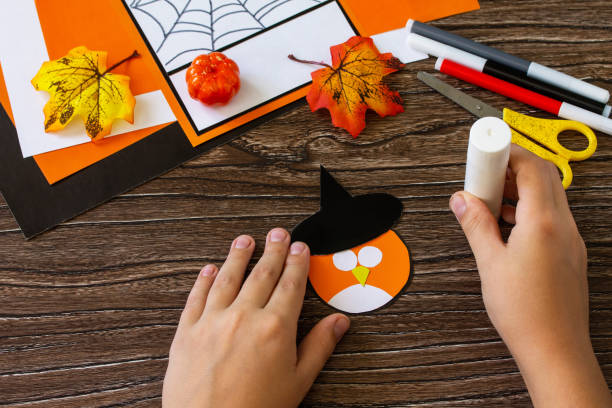 istock Instructions, step 6. Greeting card for Halloween on a wooden table. Childrens art project, handmade, crafts for children. 1269064191
