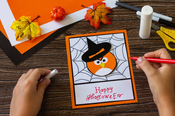 istock Instructions, step 9. Greeting card for Halloween on a wooden table. Childrens art project, handmade, crafts for children. 1269064198