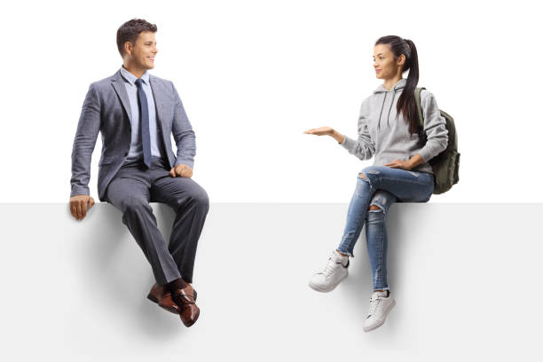 istock Professional man and a female student sitting on a blank panel and having a conversation 1269067727
