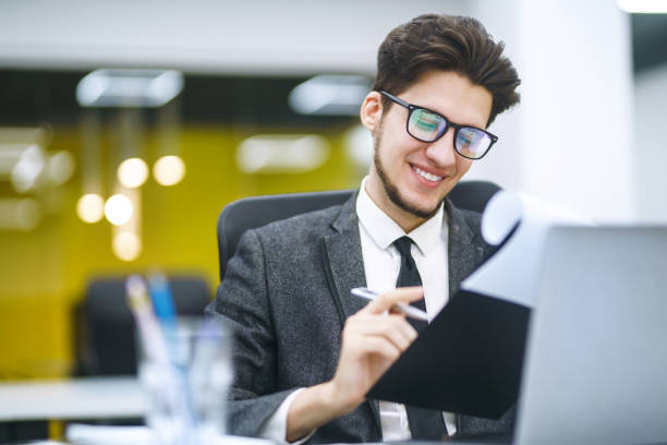 istock Stylish man in a suit working at office. 1269071680