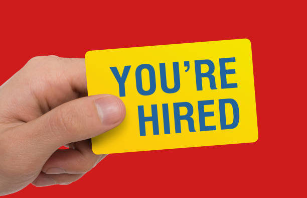 istock Headhunter showing card with phrase YOU'RE HIRED on red background, collage 1269074680