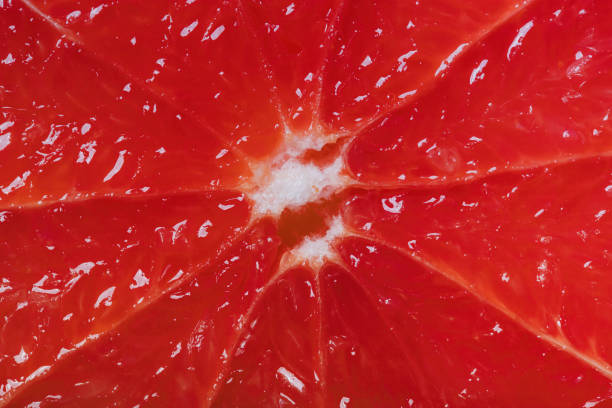 istock Cutted grapefruit background. Red juicy surface. Close up shot 1269075551