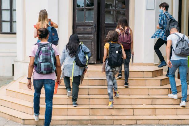 Group of students walking in college stock photo