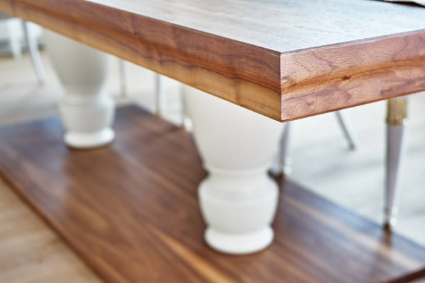 istock Wooden dinner table on massive legs in modern apartment. Close-up 1269076089