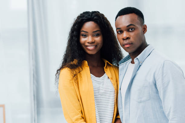 istock african american couple looking at camera at home 1269076361