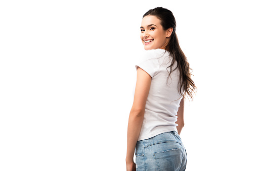 young brunette woman in white t-shirt and jeans looking at camera isolated on white