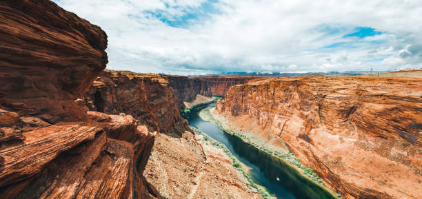 Dramatic landscape at the Grand Canyon National Park where the Colorado River runs through rock formations of eroded sand stone.