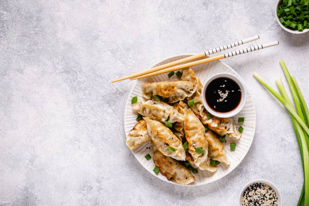 istock Fried dumplings gyoza with soy sauce, and chopsticks, top view 1269080454