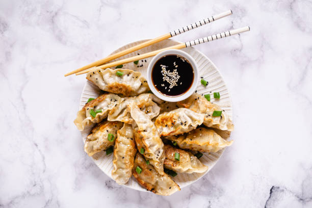 istock Fried dumplings gyoza with soy sauce, and chopsticks, top view 1269081143