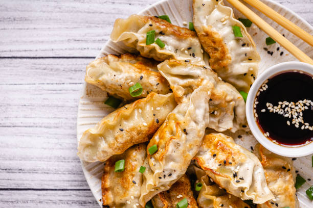 istock Fried dumplings gyoza with soy sauce, and chopsticks, top view 1269081156
