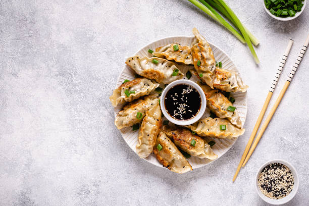 istock Fried dumplings gyoza with soy sauce, and chopsticks, top view 1269081157
