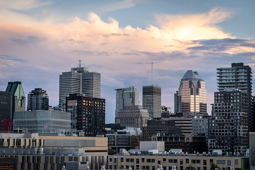 Montreal downtown cityscape with cloudy sky during sunset in summer of 2020.
