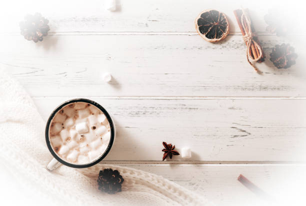 istock 1 mug of hot chocolate with marshmallows, cones, cinnamon sticks, white sweater on a white wooden background top view, place for inscription 1269088766