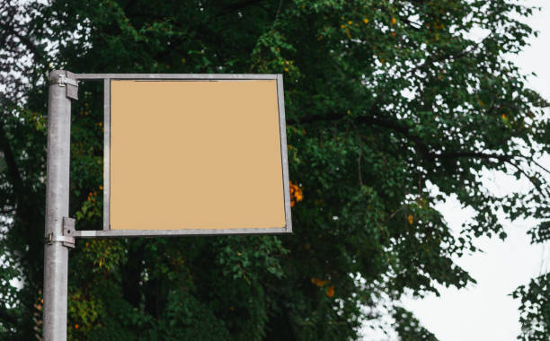 istock empty yellow sign on the background of a tree canopy in the open air, copy space 1269089314