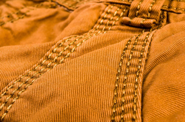 istock clothing items stonewashed cotton fabric texture with seams, clasps, buttons and rivets, macro 1269089822