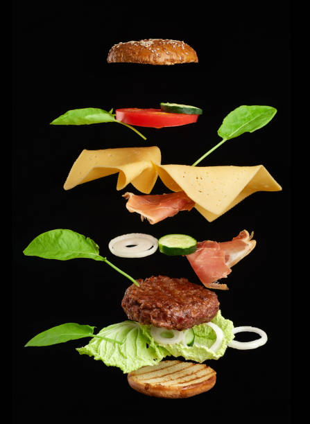 istock levitating cheeseburger ingredients: juicy meat cutlet, cheddar cheese, sesame bun 1269095437