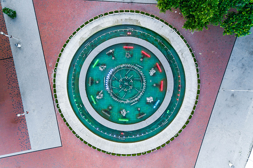 Aerial view of fountain in downtown district in  Nezavisimost Square, Varna, Bulgaria - (Bulgarian: Площад Независимост, Варна, България). A fountain sitting in the middle of a commercial district in Varna, Bulgaria. The main square of Varna is Nezavisimost Square -  where the Singing Fountain and the building of the Stoyan Bachvarov Dramatic Theatre are located. The picture was taken with DJI Phantom 4 Pro drone / quadcopter