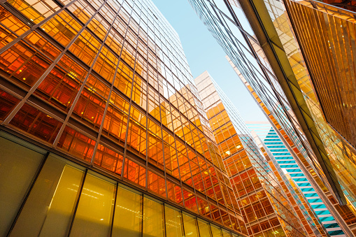 golden glass facade of modern  office building and blue sky -
