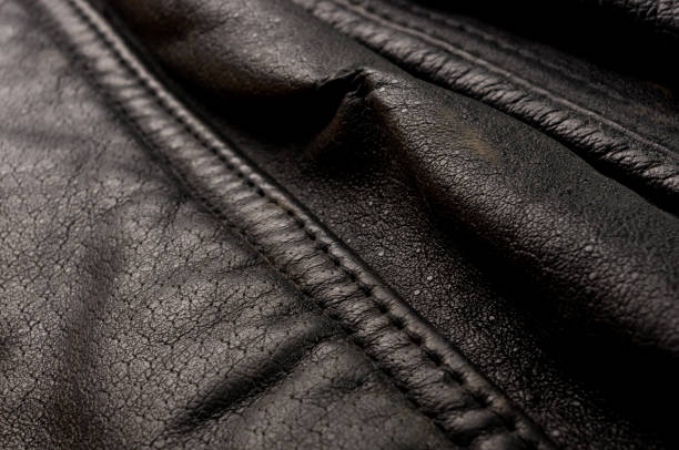 istock Old vintage genuine soft black leather texture background, top layer with pores and scratches, macro, close-up 1269098290