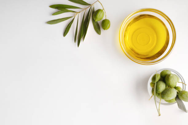 istock Bowls with oil and olives on white table detail top 1269098564