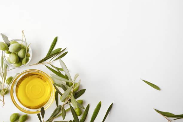 istock Glass bowl with oil and olive branches isolated on table 1269098585