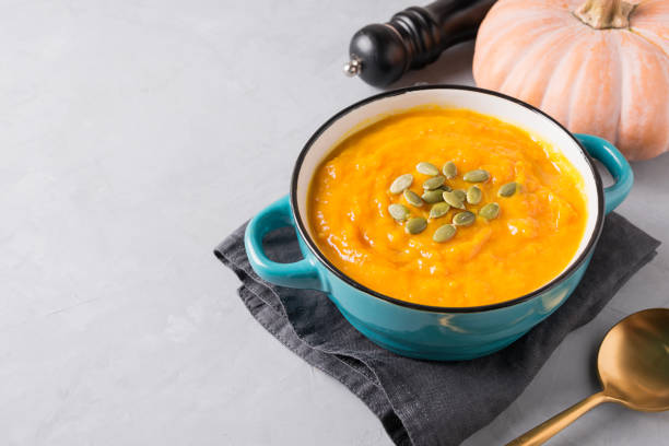 istock Fall pumpkin soup on grey background. Close up. 1269098684