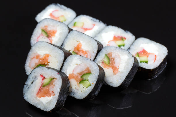 istock Sushi rolls Futo Maki on a black background. 1269099584