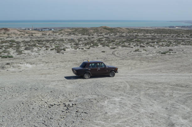 Mud Volcanoes and Lada Cab in Gobustan, Azerbaijan Traveling in Azerbaijan mud volcano stock pictures, royalty-free photos & images