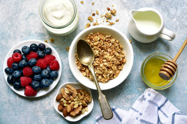 istock Healthy breakfast : granola, nuts, honey, fresh berries and dairy products 1269101470