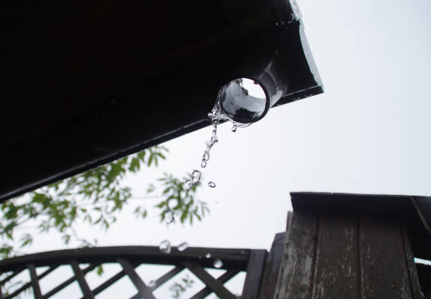 istock Water raindrops falling from the roof gutter 1269103373
