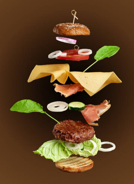 istock levitating cheeseburger ingredients: juicy meat cutlet, cheddar cheese, sesame bun 1269103577