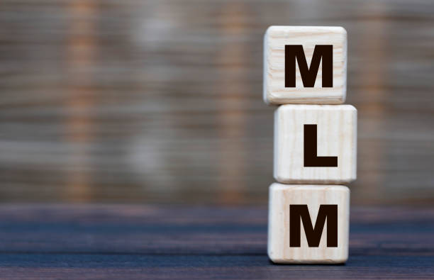 istock conceptual word MLM on cubes on a gray blurred background 1269103786
