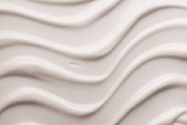 istock Milky cosmetic cream silky texture white and colored background 1269103831