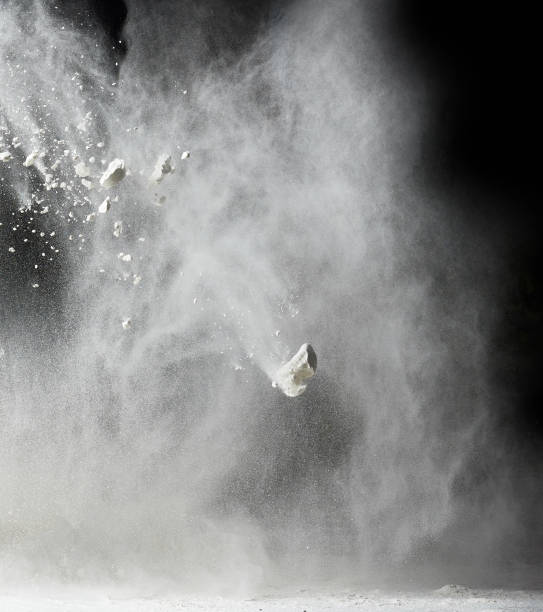 istock cloud of white wheat flour on a black background, particles fly in different directions 1269103906
