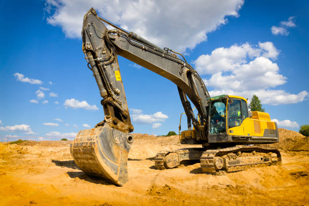 istock Yellow excavator on a highway construction site 1269107257