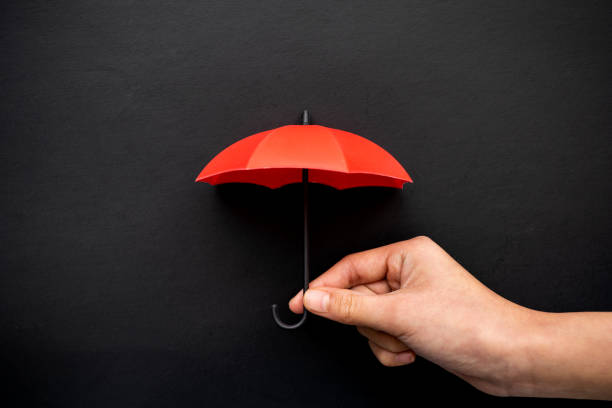istock Hand hold a small red umbrella for protection concept 1269107562