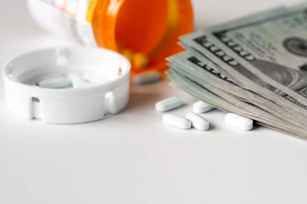 US dollar bills with medicine pills