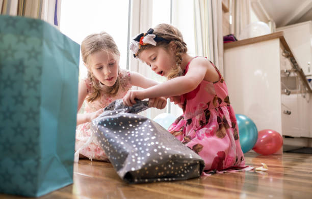 Little Girl Opening Birthday Presents stock photo