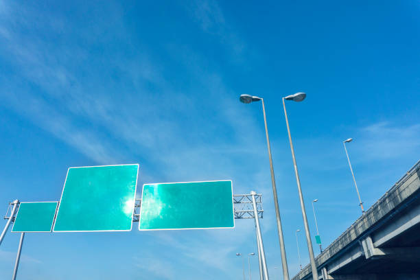 istock Blank green road sign on highway, empty traffic sign blue sky background 1269110534