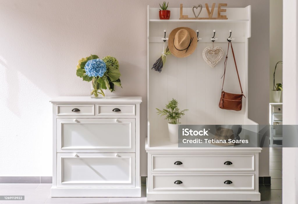 Home interior. White wooden furniture at entryway. Small foyer organisation decision. Entrance Hall Stock Photo