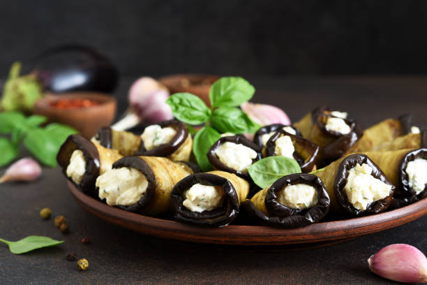 istock Grilled eggplants with cheese, nuts and garlic on a concrete background. 1269114247