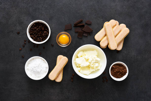 istock Ingredients for preparing tiramisu on a black background. Cooking process. Classic Italian dessert. 1269114260