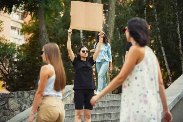 Photo of Dude with sign - woman stands protesting things that annoy her