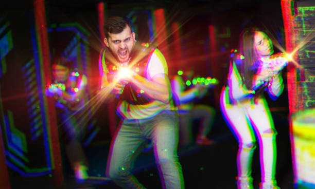 istock Excited guy laser tag player in bright beams 1269117239