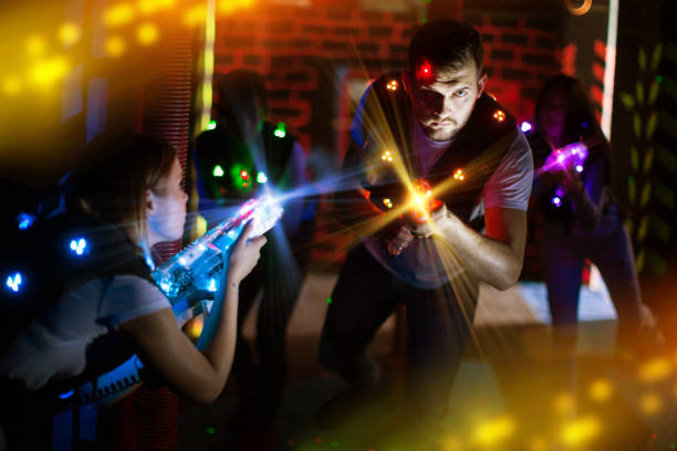 istock Excited guy laser tag player in bright beams 1269117268