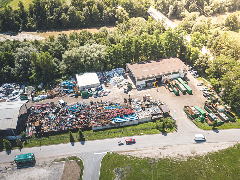 Aerial view of waste recycling center junkyard. Pile of garbage and trash in a small city dump site or landfill.
