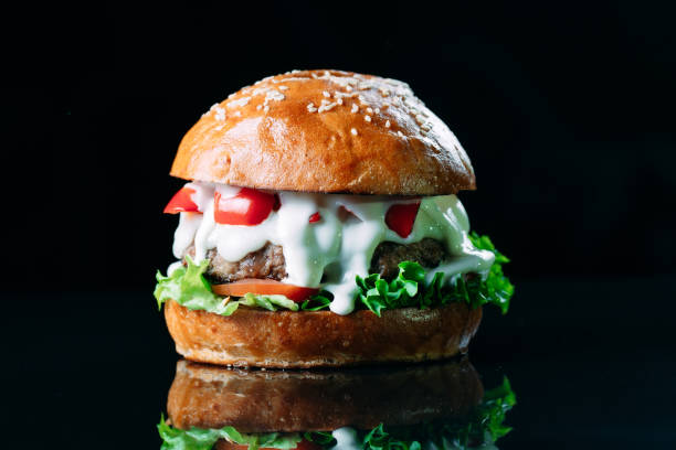 istock Juicy beef Burger on a black background. 1269122292