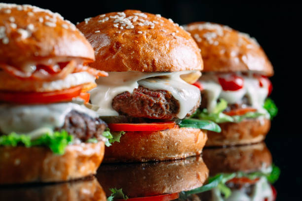istock Juicy beef Burgers on a black background. 1269122593