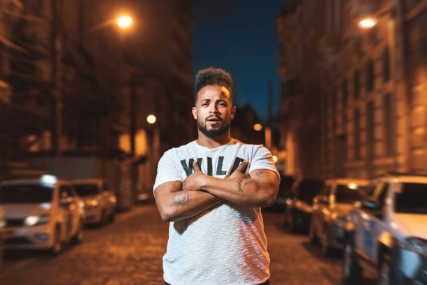 Man with arms crossed at night Afro man, Punk, Lifestyle, Nightlife, Brazil graphic print photos stock pictures, royalty-free photos & images