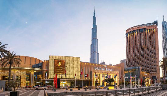 Dubai, United Arab Emirates - August 25, 2020: Dubai mall main entrance panoramic view with Burj Khalifa in rising in the background. Largest shopping mall by area and one of the main attractions in Dubai, UAE